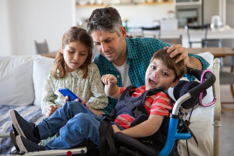 a father, daughter, and disabled son in a wheelchair